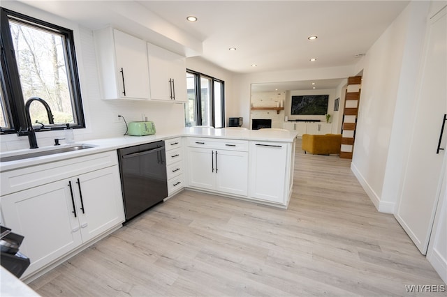 14 Wynngate Ln, Amherst, NY 14221 - kitchen featuring dishwashing machine, open floor plan, a peninsula, white cabinets, and light wood-style flooring