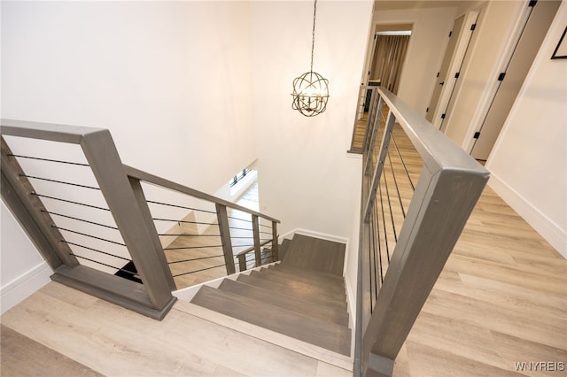 14 Wynngate Ln, Amherst, NY 14221 - stairs featuring wood finished floors and a chandelier