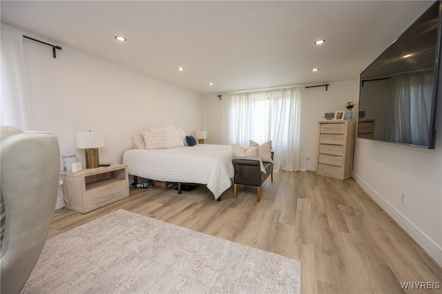 bedroom with light wood-type flooring, recessed lighting, and baseboards