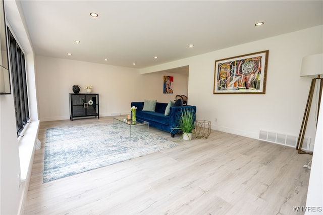 living room with recessed lighting, wood finished floors, and baseboards