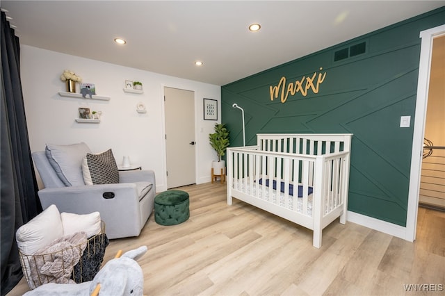 14 Wynngate Ln, Amherst, NY 14221 - bedroom featuring wood finished floors, recessed lighting, and a crib