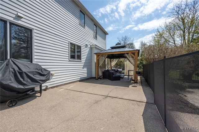 view of parking / parking lot featuring a gazebo and fence