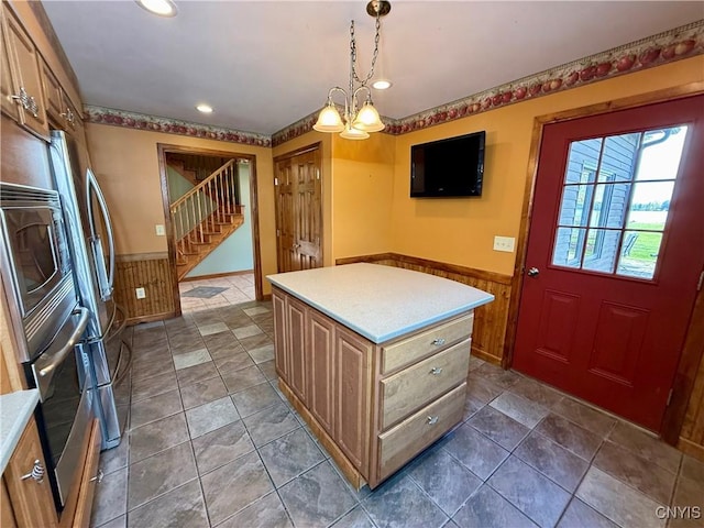 657 W Cottage Ln, Deruyter, NY 13052 - kitchen featuring oven, a wainscoted wall, light countertops, recessed lighting, and hanging light fixtures