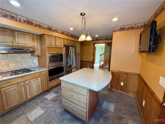 657 W Cottage Ln, Deruyter, NY 13052 - kitchen with stainless steel appliances, a wainscoted wall, under cabinet range hood, light countertops, and wood walls