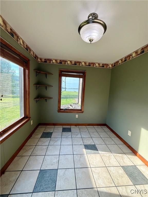 657 W Cottage Ln, Deruyter, NY 13052 - spare room with light tile patterned floors and baseboards