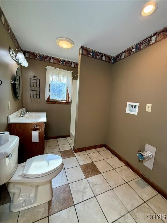 657 W Cottage Ln, Deruyter, NY 13052 - bathroom featuring toilet, vanity, baseboards, and tile patterned floors