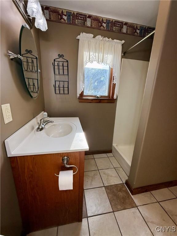 657 W Cottage Ln, Deruyter, NY 13052 - full bath with vanity, a shower, baseboards, and tile patterned flooring