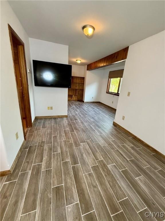 657 W Cottage Ln, Deruyter, NY 13052 - unfurnished living room featuring dark wood-type flooring and baseboards