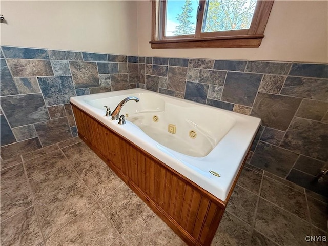657 W Cottage Ln, Deruyter, NY 13052 - bathroom featuring a tub with jets and stone finish flooring