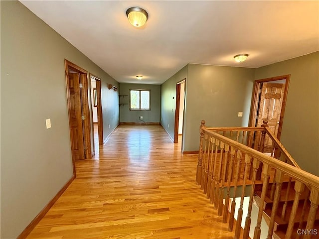 657 W Cottage Ln, Deruyter, NY 13052 - hallway with light wood-style flooring, baseboards, and an upstairs landing