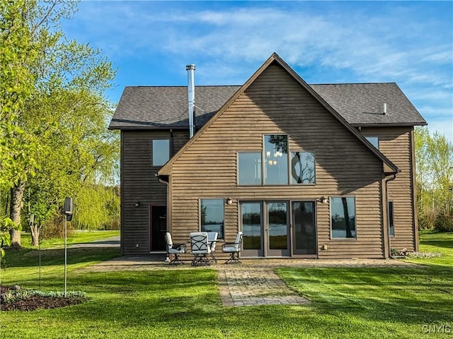 657 W Cottage Ln, Deruyter, NY 13052 - rear view of house with a patio, a yard, and a shingled roof