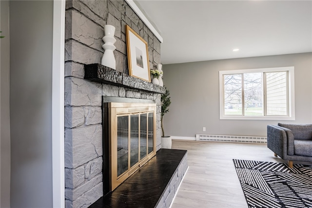 848 Weiland Rd, Greece, NY 14626 - living area featuring baseboard heating, wood finished floors, a stone fireplace, baseboards, and recessed lighting