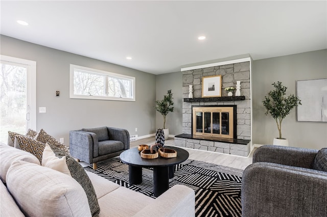 848 Weiland Rd, Greece, NY 14626 - living area with wood finished floors, recessed lighting, a stone fireplace, and baseboards