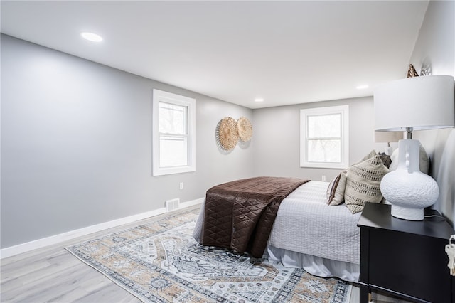 848 Weiland Rd, Greece, NY 14626 - bedroom featuring wood finished floors, multiple windows, baseboards, and recessed lighting