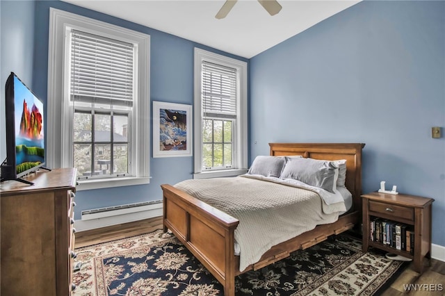 125 Edward St Unit 2G, Buffalo, NY 14201 - bedroom with a baseboard heating unit, wood finished floors, baseboards, and ceiling fan
