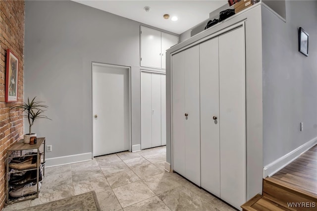 125 Edward St Unit 2G, Buffalo, NY 14201 - hall with baseboards and brick wall