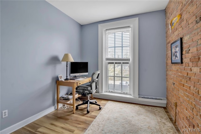 125 Edward St Unit 2G, Buffalo, NY 14201 - office area with wood finished floors, baseboards, brick wall, and baseboard heating