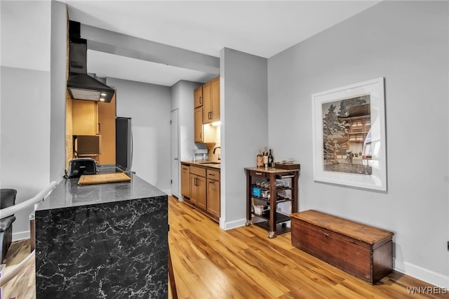 125 Edward St Unit 2G, Buffalo, NY 14201 - kitchen with light wood-type flooring, a sink, dark countertops, fridge, and baseboards
