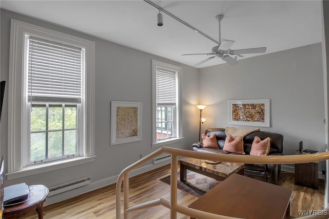 125 Edward St Unit 2G, Buffalo, NY 14201 - bedroom with a baseboard radiator, light wood finished floors, baseboards, and a desk
