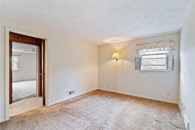 empty room with carpet floors and baseboards