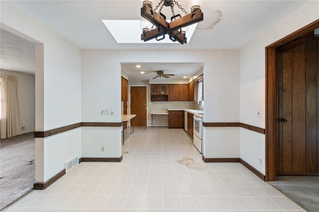 kitchen with white electric stove, plenty of natural light, baseboards, recessed lighting, and light countertops