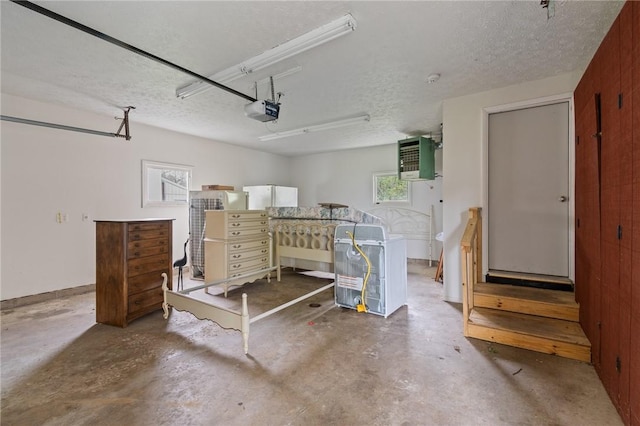 garage featuring a garage door opener and freestanding refrigerator