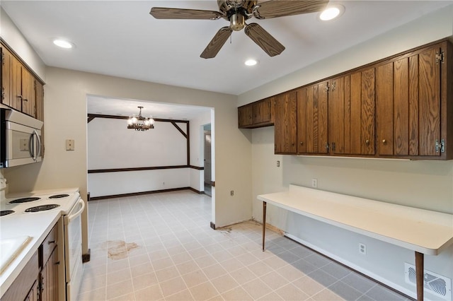 kitchen featuring stainless steel microwave, white range with electric cooktop, a chandelier, light countertops, and ceiling fan
