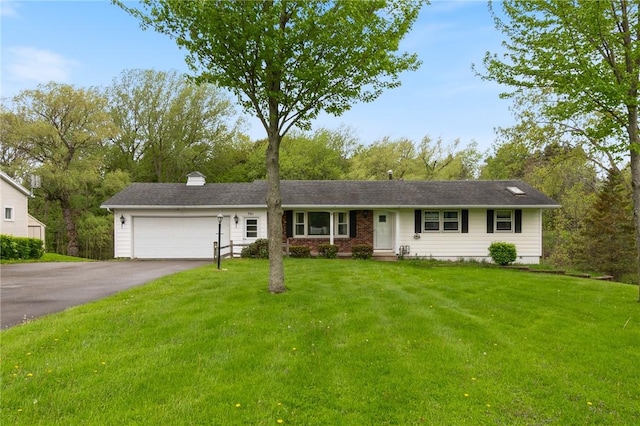ranch-style home with asphalt driveway, a garage, and a front yard