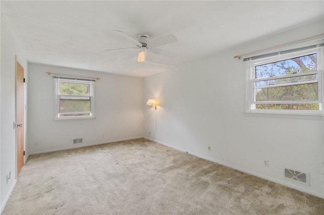 unfurnished room with carpet flooring, ceiling fan, and baseboards
