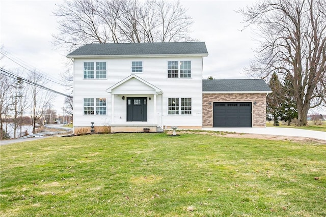 1965 Main St, Carlton, NY 14571 - colonial home with concrete driveway, an attached garage, and a front yard