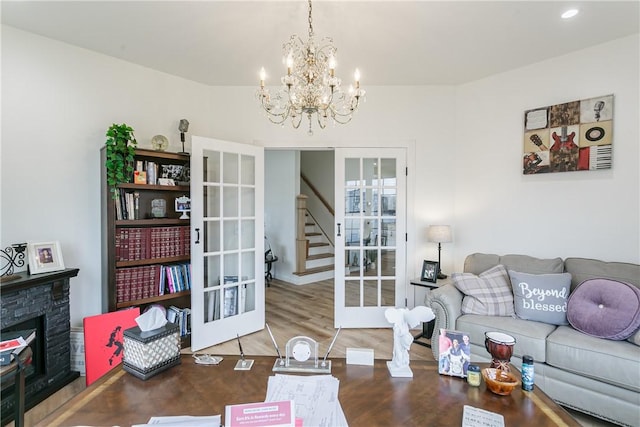 1965 Main St, Carlton, NY 14571 - living area with french doors, a fireplace, a chandelier, stairway, and recessed lighting