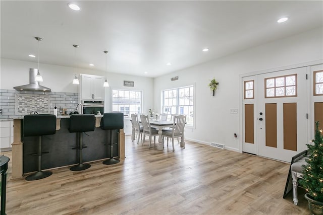 1965 Main St, Carlton, NY 14571 - kitchen featuring exhaust hood, oven, light countertops, recessed lighting, and white cabinetry