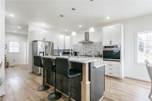 1965 Main St, Carlton, NY 14571 - kitchen featuring appliances with stainless steel finishes, range hood, decorative backsplash, healthy amount of natural light, and recessed lighting