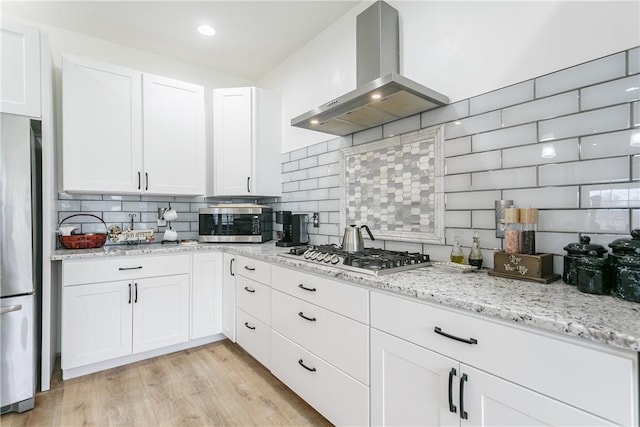 1965 Main St, Carlton, NY 14571 - kitchen with extractor fan, stainless steel appliances, backsplash, and white cabinetry