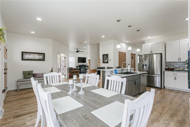 1965 Main St, Carlton, NY 14571 - dining room with light wood-style floors, a ceiling fan, recessed lighting, and a glass covered fireplace