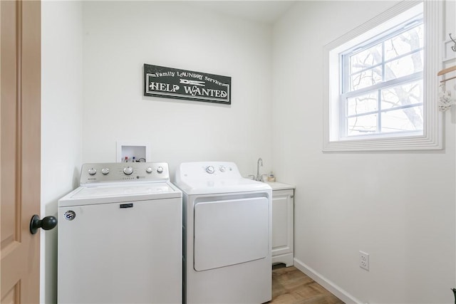 1965 Main St, Carlton, NY 14571 - clothes washing area with washing machine and clothes dryer, cabinet space, light wood-type flooring, and baseboards