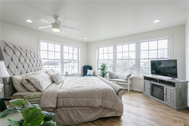 1965 Main St, Carlton, NY 14571 - bedroom featuring multiple windows, light wood-style floors, recessed lighting, ceiling fan, and a fireplace