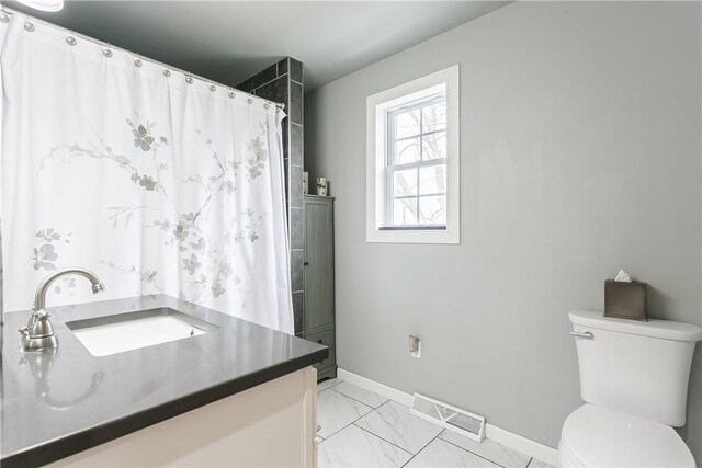 1965 Main St, Carlton, NY 14571 - full bath with baseboards, marble look tile flooring, toilet, vanity, and a shower with curtain