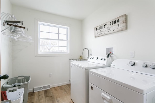 1965 Main St, Carlton, NY 14571 - laundry area featuring washer and dryer, light wood-style flooring, and baseboards