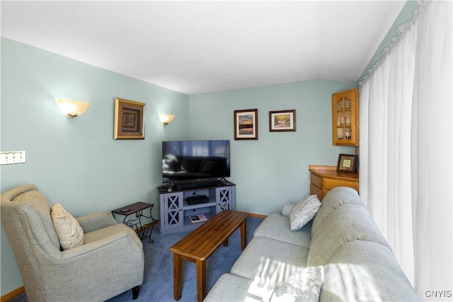 living area featuring carpet floors and vaulted ceiling
