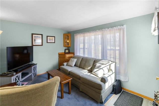 carpeted living room featuring baseboards