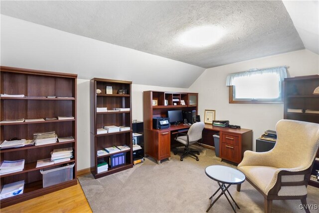 office area featuring a textured ceiling and lofted ceiling