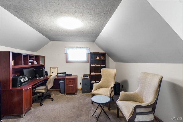 carpeted office space featuring lofted ceiling and a textured ceiling