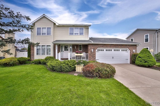 2651 Ferchen St, Wheatfield, NY 14304 - traditional home with brick siding, a front yard, an attached garage, and driveway