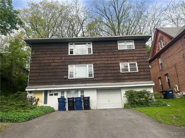 1018-20 Ackerman Ave Unit 1020, Syracuse, NY 13210 - view of side of home with a garage, driveway, and stucco siding
