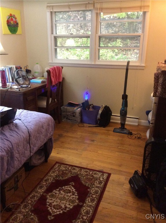 1018-20 Ackerman Ave Unit 1020, Syracuse, NY 13210 - bedroom featuring wood finished floors and a baseboard heating unit