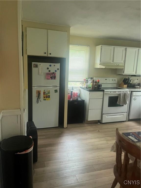 1018-20 Ackerman Ave Unit 1020, Syracuse, NY 13210 - kitchen featuring white appliances, white cabinets, light wood-type flooring, and under cabinet range hood