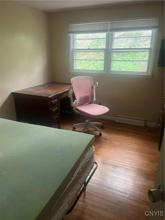1018-20 Ackerman Ave Unit 1020, Syracuse, NY 13210 - bedroom with a baseboard heating unit, wood finished floors, and baseboards
