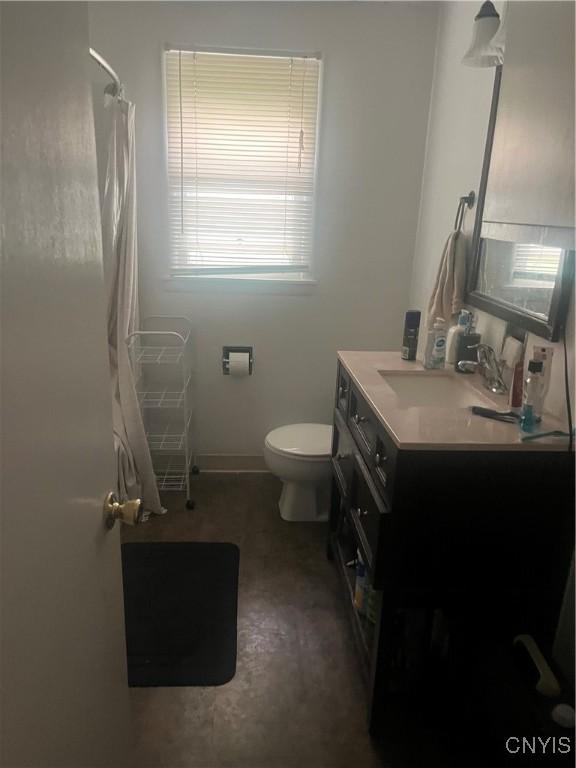 1018-20 Ackerman Ave Unit 1020, Syracuse, NY 13210 - bathroom featuring toilet, vanity, curtained shower, and baseboards