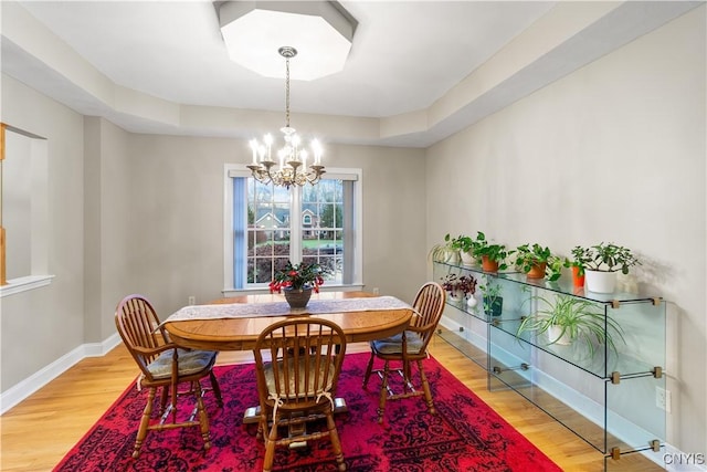 8312 Partridgeberry Dr, Lysander, NY 13027 - dining room with a chandelier, light wood-style flooring, and baseboards